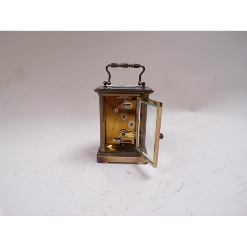 1455 - MATTHEW NORMAN BRASS CARRIAGE CLOCK 14cms H WITH THE HANDLE RAISED