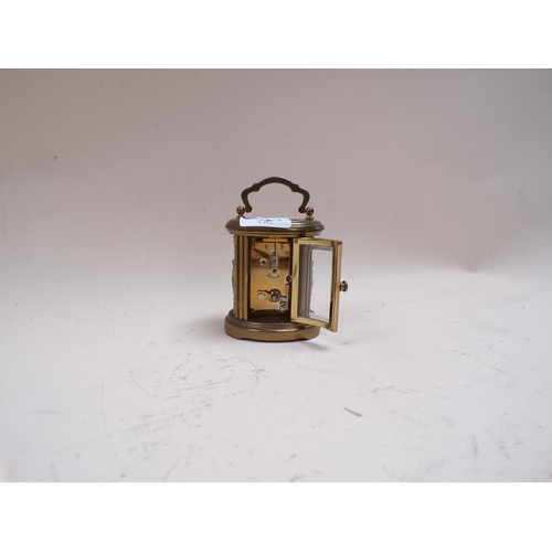 1456 - 20c GILT METAL MATTHEW NORMAN SMALL CARRIAGE TYPE CLOCK WITH CAST SIDE PANELS - 10cms H