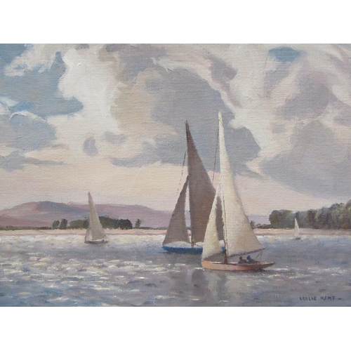 1252 - LESLIE KENT - FOUR SAILING VESSELS ON A LAKE, SIGNED OIL ON CANVAS, FRAMED, 35CM X 44CM