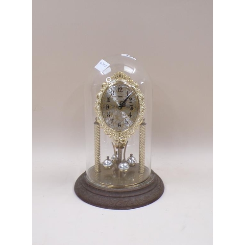 1341 - GILT METAL MANTEL CLOCK UNDER A GLASS DOME 27cms H