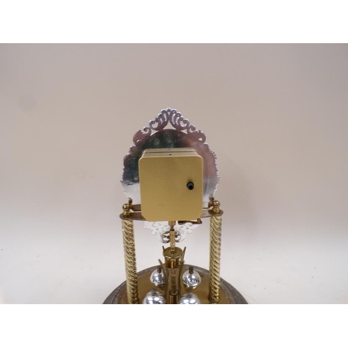 1341 - GILT METAL MANTEL CLOCK UNDER A GLASS DOME 27cms H