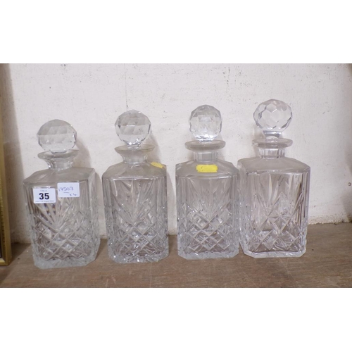 35 - FOUR CRYSTAL DECANTERS AND STOPPERS