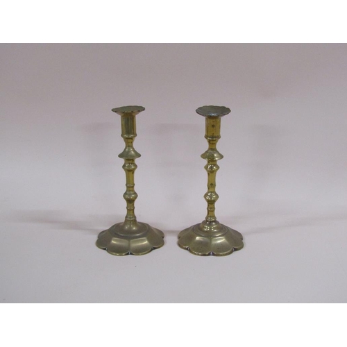 42 - A pair of 18c brass petal based double knop candlesticks, 24cm h.