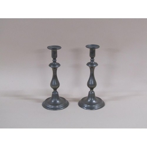 45 - A pair of early 19c pewter baluster candlesticks with wide circular stepped bases, having a beaded k... 