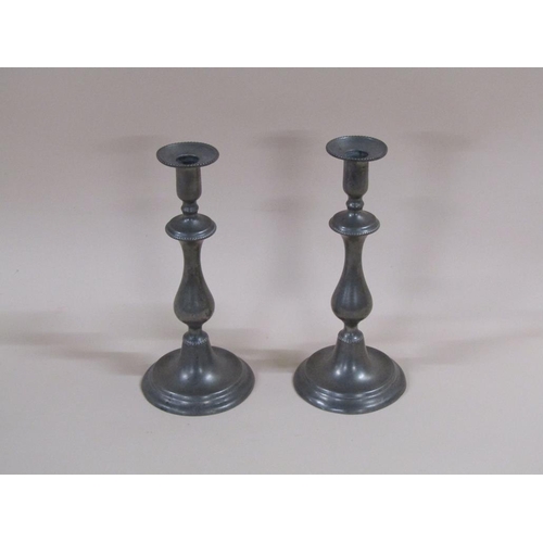 45 - A pair of early 19c pewter baluster candlesticks with wide circular stepped bases, having a beaded k... 