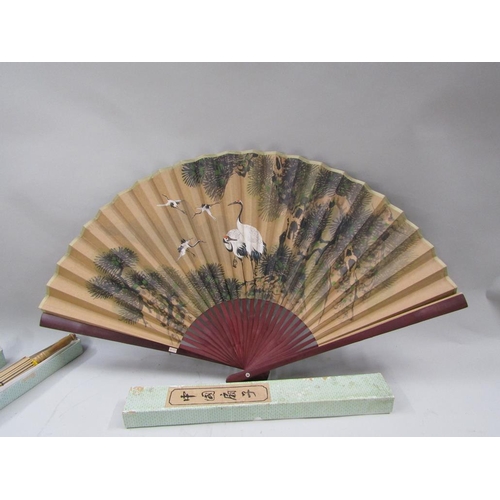 1166 - TWO ORIENTAL PARASOLS AND ONE LARGE FAN - 60cms H