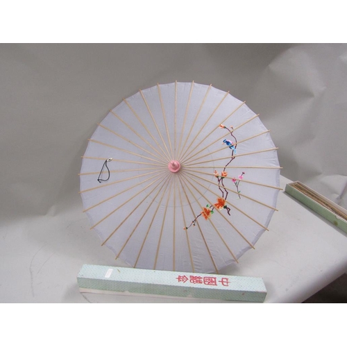 1166 - TWO ORIENTAL PARASOLS AND ONE LARGE FAN - 60cms H