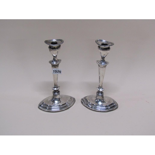 1520 - TWO SILVER CASED CANDLESTICKS