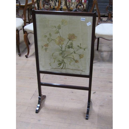 1713 - MAHOGANY FRAMED SCREEN WITH A FLORAL NEEDLEWORK PANEL 55 x 97 cms