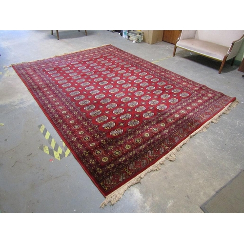 1739 - ORIENTAL RED GROUND WOOLLEN RUG 346 x 249cms