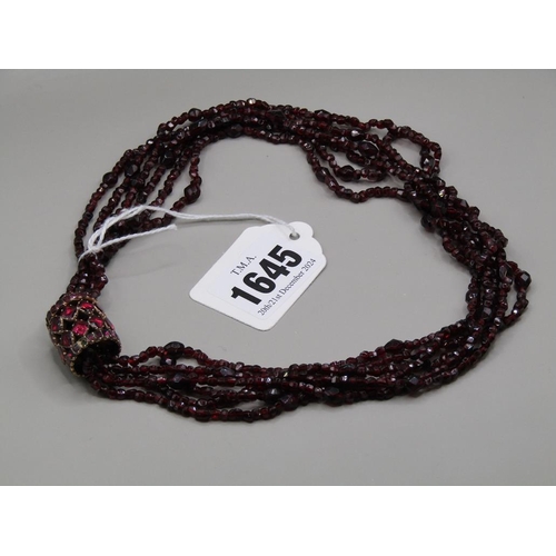 1645 - QUADRUPLE STRAND OF GARNET BEADS WITH A GOLD GARNET SET BARREL CLASP