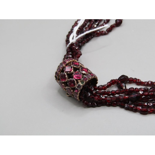 1645 - QUADRUPLE STRAND OF GARNET BEADS WITH A GOLD GARNET SET BARREL CLASP