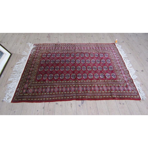 1666 - PERSIAN STYLE RED GROUND RUG - 127CM X 203CM