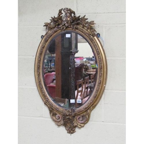 1252 - GILT WOOD AND STUCCO OVAL WALL MIRROR - 19C STYLE, 90CM X 54CM