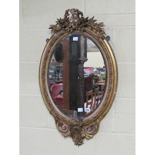 1252 - GILT WOOD AND STUCCO OVAL WALL MIRROR - 19C STYLE, 90CM X 54CM