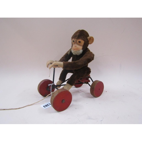 1383 - GERMAN STUFFED TOY MONKEY ON A CART, 24CM H