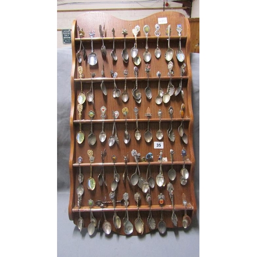 35 - SOUVENIR SPOONS IN RACK