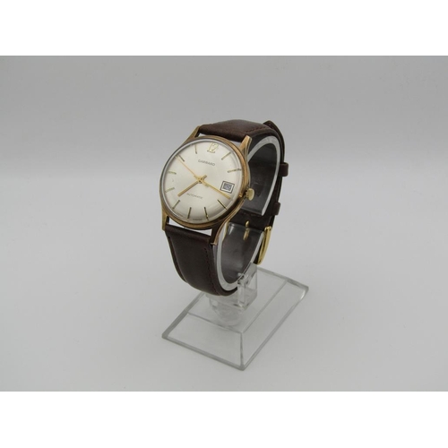 1608 - 9ct GOLD GARRARD AUTOMATIC WATCH ON BROWN LEATHER STRAP