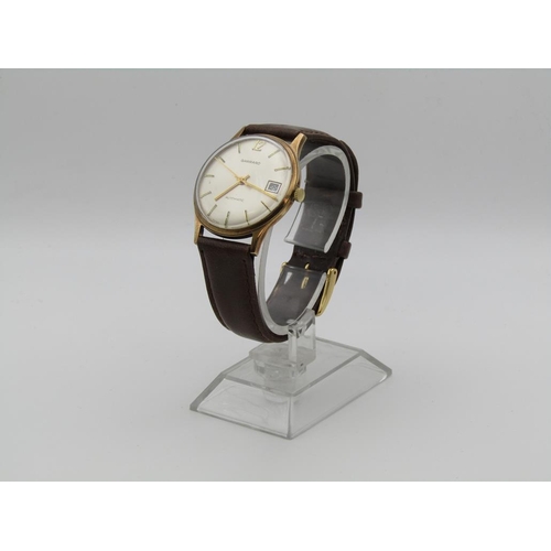1608 - 9ct GOLD GARRARD AUTOMATIC WATCH ON BROWN LEATHER STRAP
