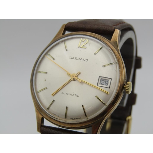 1608 - 9ct GOLD GARRARD AUTOMATIC WATCH ON BROWN LEATHER STRAP