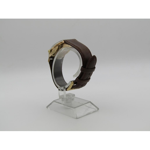 1608 - 9ct GOLD GARRARD AUTOMATIC WATCH ON BROWN LEATHER STRAP