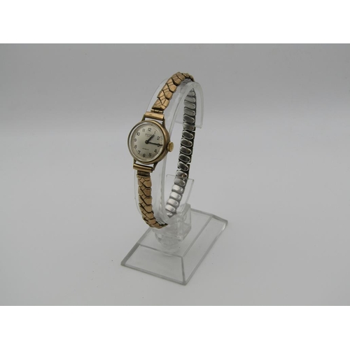 1630 - 9ct GOLD CASED AVIA LADIES WATCH ON EXPANDING PLATED STRAP
