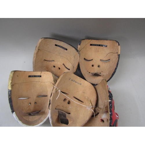 1357 - FIVE ORIENTAL CARVED WOODEN MASKS, 20CM H