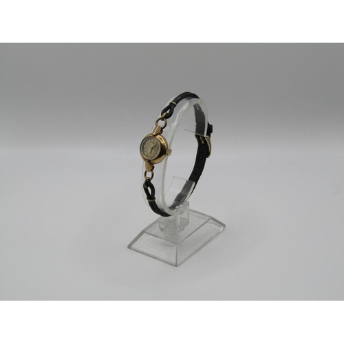 1446 - 9ct GOLD CASED LADIES LONGINES WATCH ON A BLACK LEATHER STRAP