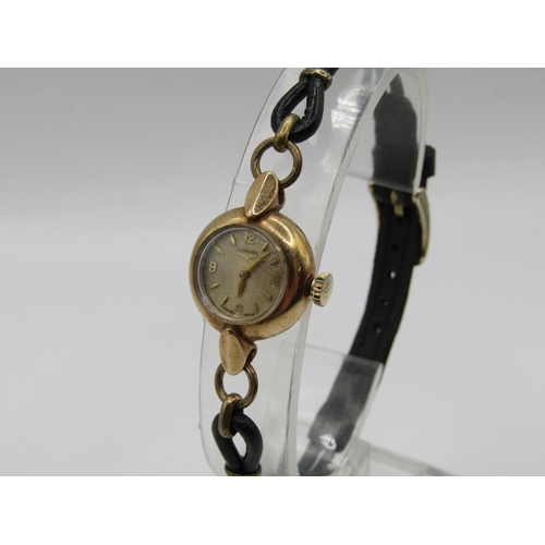 1446 - 9ct GOLD CASED LADIES LONGINES WATCH ON A BLACK LEATHER STRAP