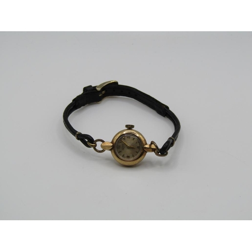 1446 - 9ct GOLD CASED LADIES LONGINES WATCH ON A BLACK LEATHER STRAP