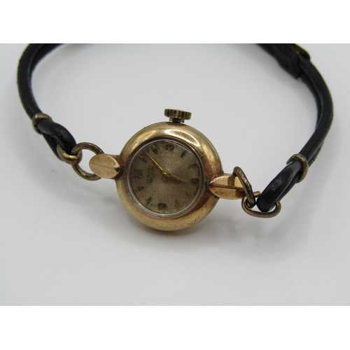 1446 - 9ct GOLD CASED LADIES LONGINES WATCH ON A BLACK LEATHER STRAP