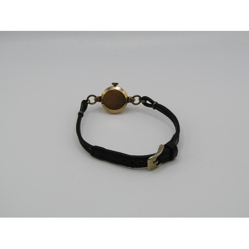 1446 - 9ct GOLD CASED LADIES LONGINES WATCH ON A BLACK LEATHER STRAP