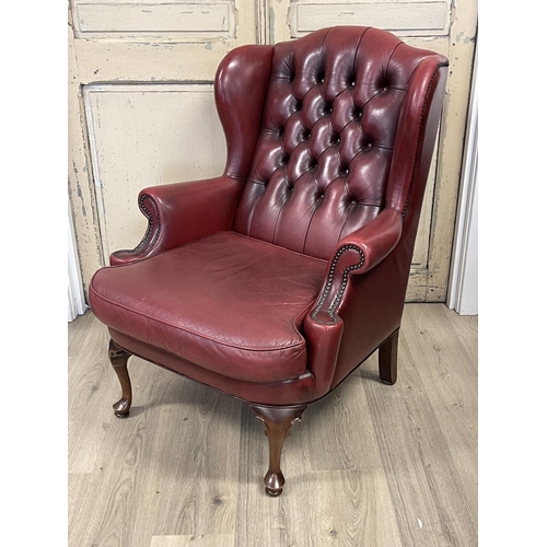 1099 - Moran burgundy leather buttoned back wing lounge armchair