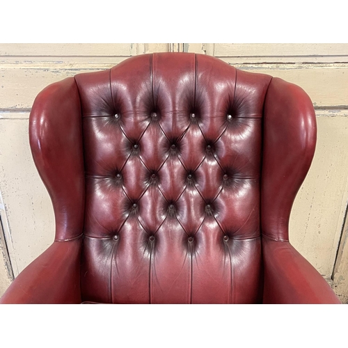 1099 - Moran burgundy leather buttoned back wing lounge armchair