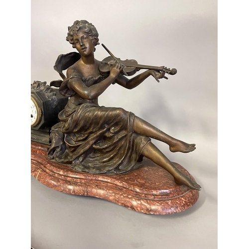 1073 - Antique French figural spelter clock, of a maiden playing a violin, bow to the violin has a fracture... 