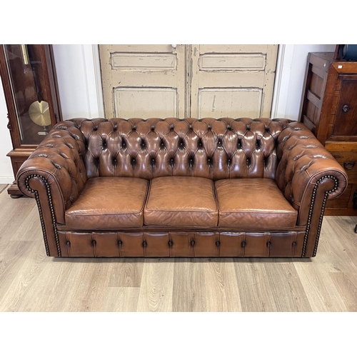 1100 - Moran brown leather deep buttoned three seater Chesterfield, approx 67cm H x 193cm W x 91cm D