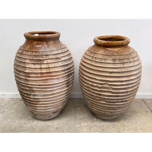 1117 - Two antique large rope coil design pottery storage jars, approx 86cm H x 52cm dia and smaller (2)