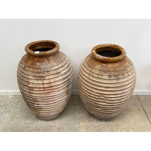 1117 - Two antique large rope coil design pottery storage jars, approx 86cm H x 52cm dia and smaller (2)