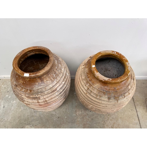 1117 - Two antique large rope coil design pottery storage jars, approx 86cm H x 52cm dia and smaller (2)