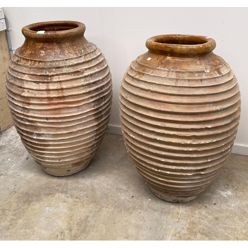 1117 - Two antique large rope coil design pottery storage jars, approx 86cm H x 52cm dia and smaller (2)