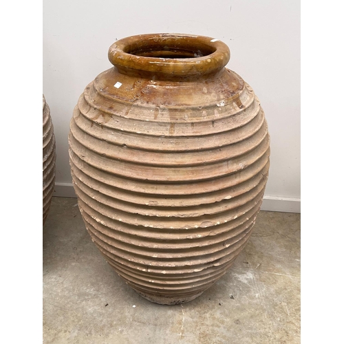 1117 - Two antique large rope coil design pottery storage jars, approx 86cm H x 52cm dia and smaller (2)