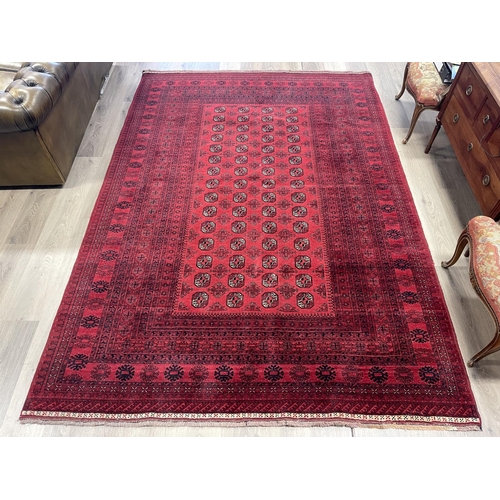 1122 - Hand knotted pure wool Afghan Bukhara carpet, approx 299cm x 204cm