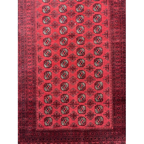 1122 - Hand knotted pure wool Afghan Bukhara carpet, approx 299cm x 204cm