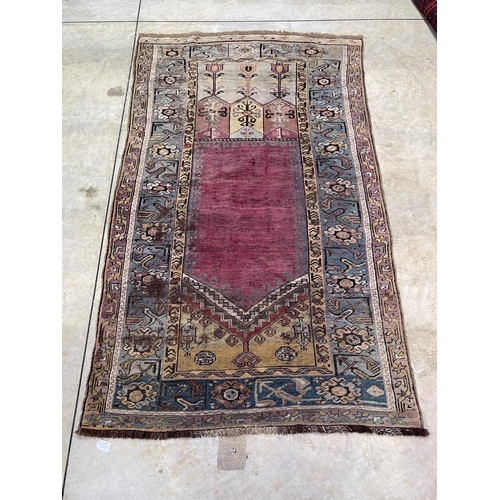 1125 - A Central Anatolian Ludik wool prayer rug with a geometric niche, approx 187cm x 107cm