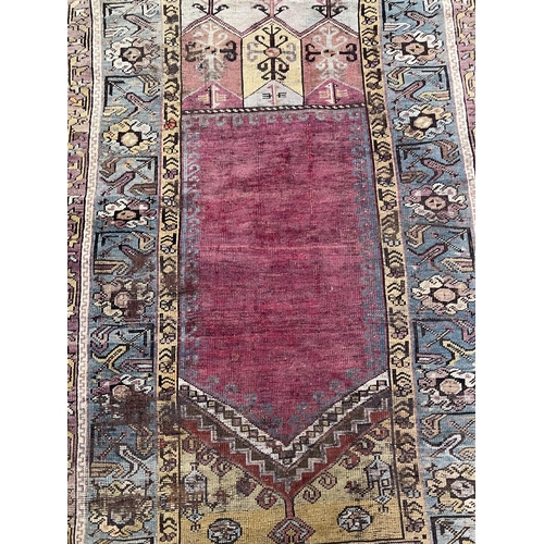 1125 - A Central Anatolian Ludik wool prayer rug with a geometric niche, approx 187cm x 107cm