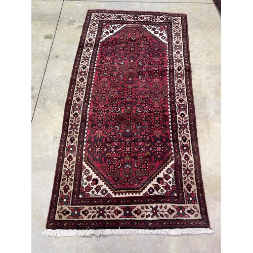 1126 - Hand knotted wool carpet of red ground, approx 182 cm x 95 cm