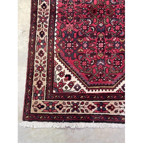 1126 - Hand knotted wool carpet of red ground, approx 182 cm x 95 cm