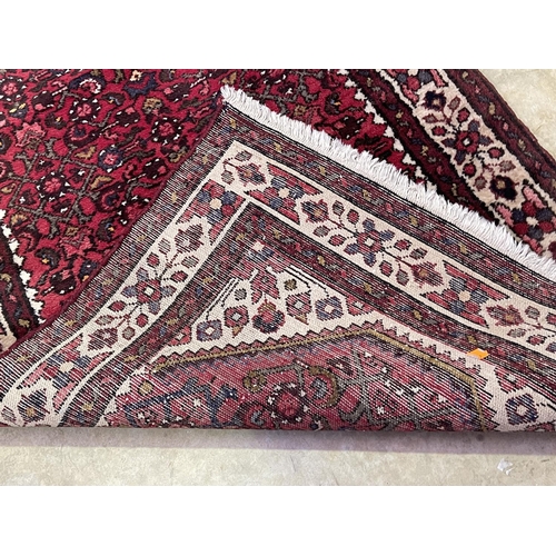 1126 - Hand knotted wool carpet of red ground, approx 182 cm x 95 cm
