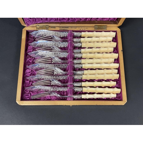 1134 - Cased set of antique fish knives and forks, with hawthorn branch form ivory handles, bright cut deco... 