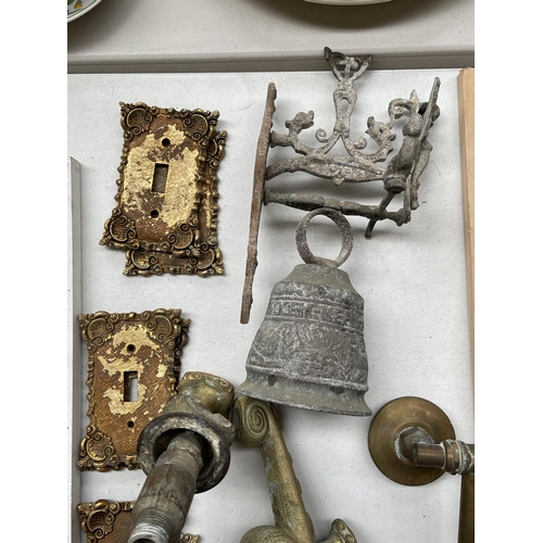 104 - Assortment of cast brass tap fittings, bell & brass switch plates